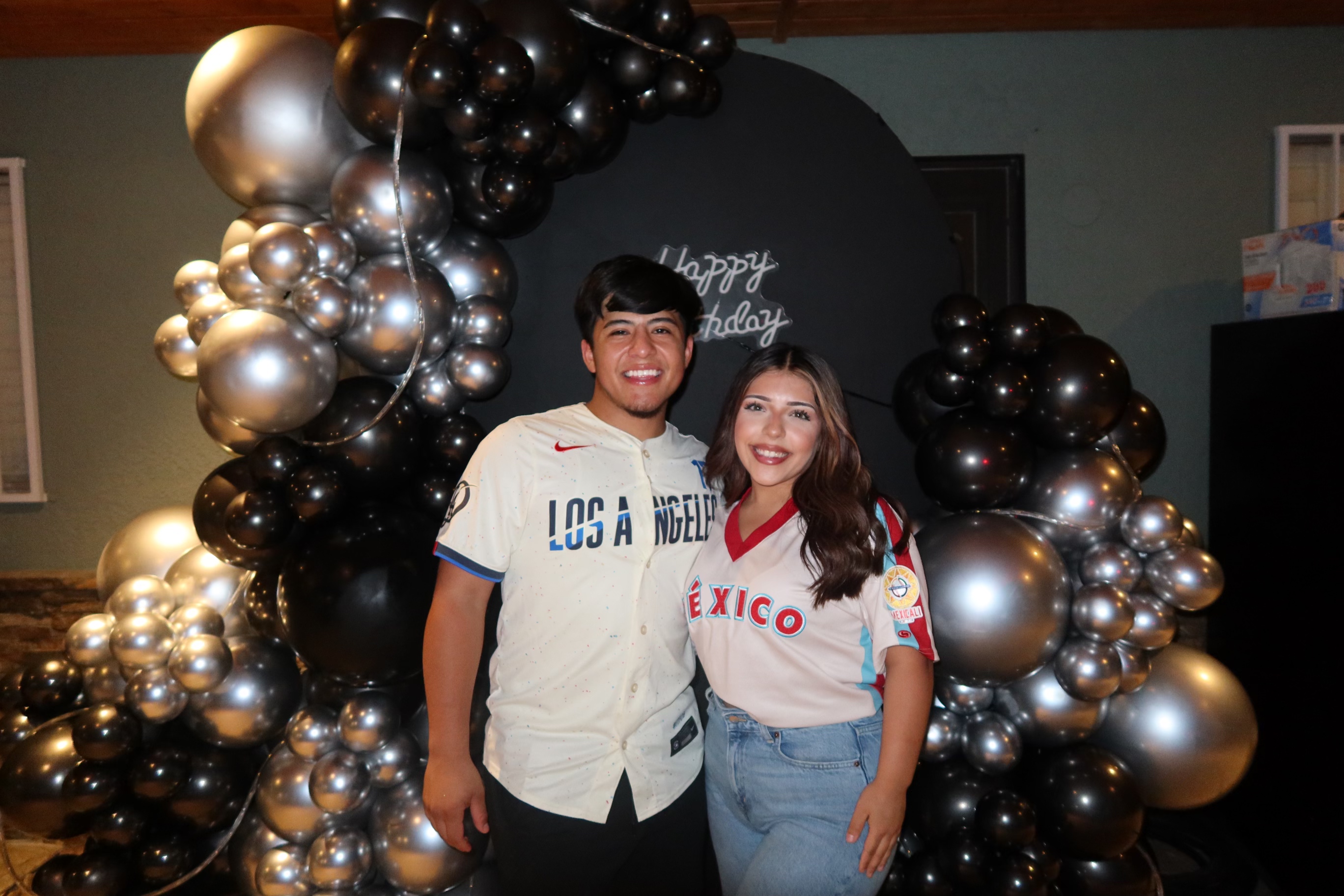 Kassandra and Jacob smiling together at a birthday celebration